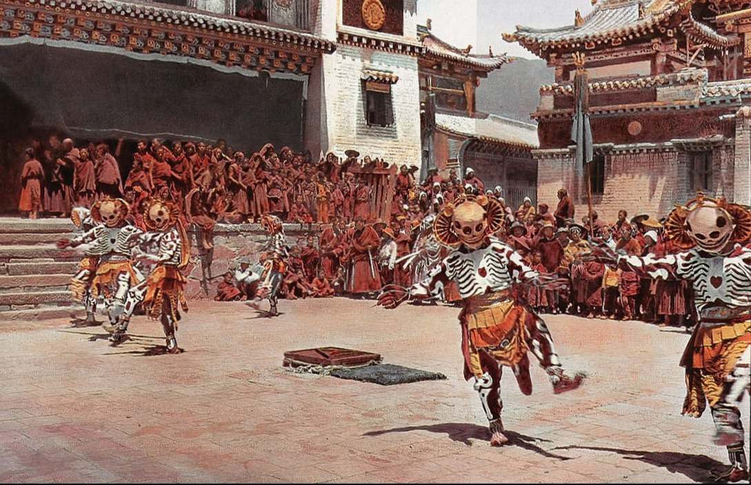 Tibetan dancers in skeleton costumes in 1925 dance in a public square as many people stand watching