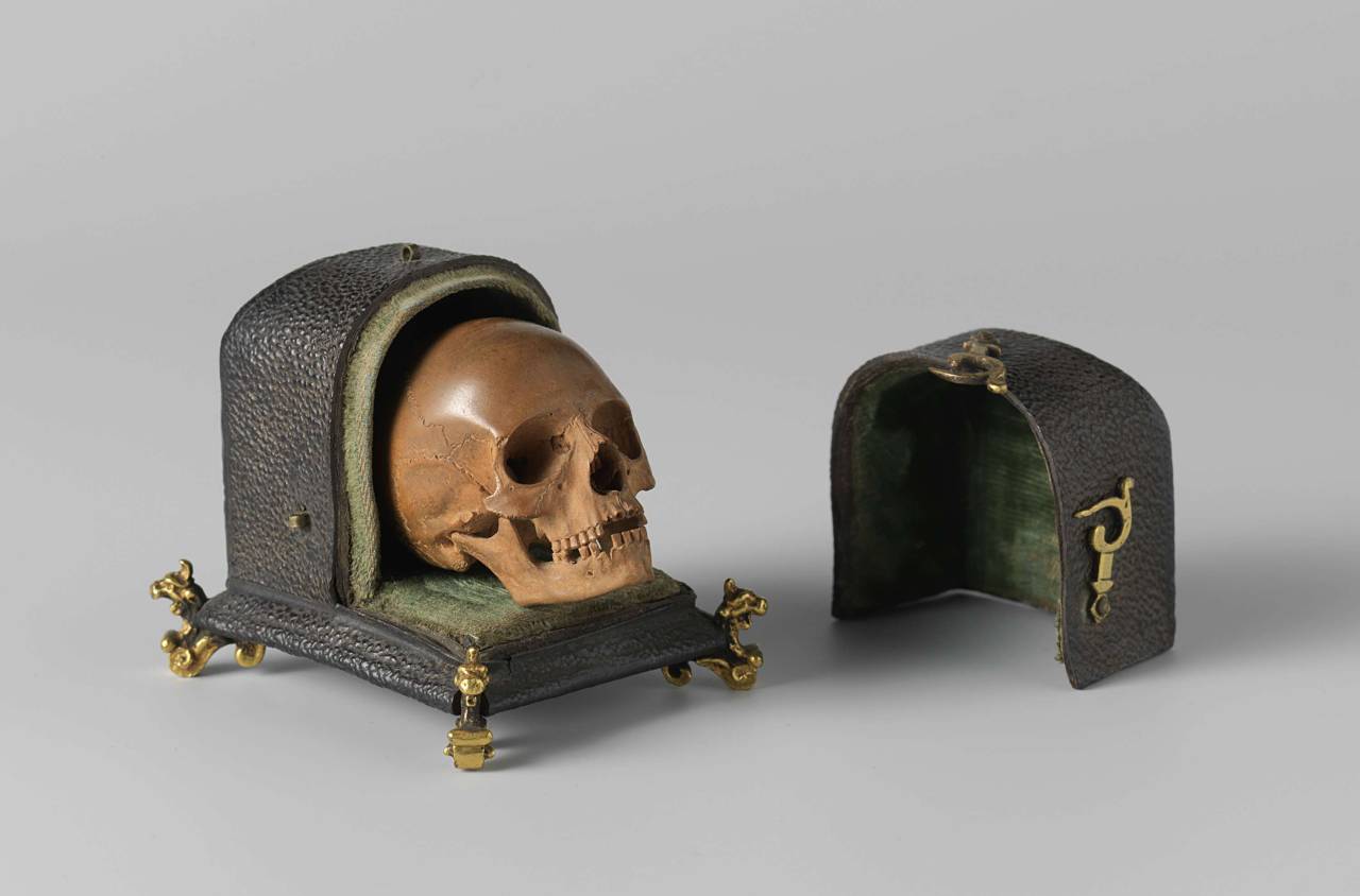 small carved skull in a case